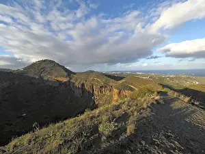 Range of hills under extended sky