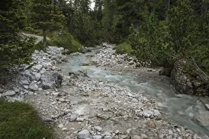 Rapid river flowing through the valley in the Italian Dolomites