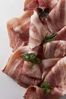 Raw bacon, sliced, with micro greenery and spices