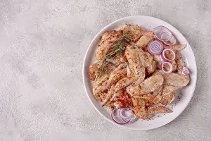 Raw chicken wings, marinated with spices