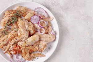 Raw chicken wings, marinated with spices