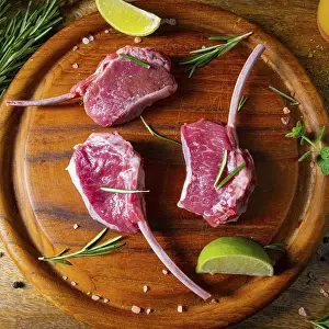 Raw fresh lamb chops Wooden chopping board