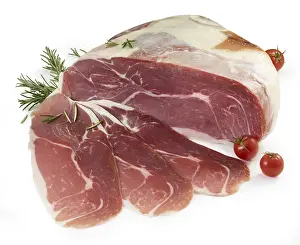 Raw ham, decorated with tomatoes and rosemary