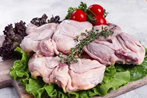 Raw quail meat, three quail carcasses