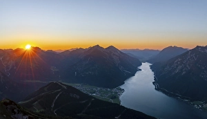 Last rays of sun over mountain landscape at sunset