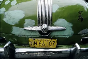 Rear of a US-vintage car, rusty spots covered with paint on the trunk lid