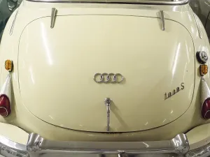 Rear view of a cream-coloured Audi classic car with chrome details and classic shapes