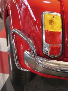 Rear view of a red classic car with characteristic tail lights