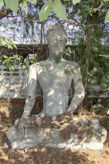 The reconstruction Buddha statue sitting under tropical tree