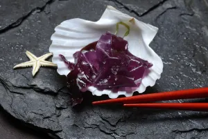 Red alga with sea salt in mussel shell and chopsticks