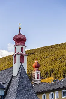 Red bell towers of the church of a mountain village in Italy
