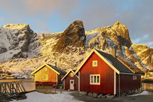 Red boathouse in winter landscape