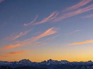 Red-colored plume clouds over the Berchtesgaden Alps at dusk