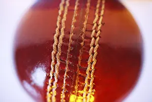 Red colour cricket ball seam on white background
