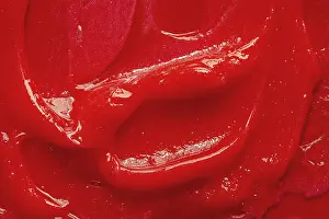 Red gel texture. Cosmetic clear liquid cream smudge