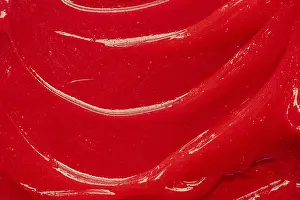 Red gel texture. Cosmetic clear liquid cream smudge