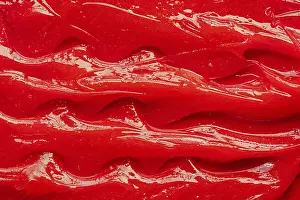 Red gel texture. Cosmetic clear liquid cream smudge