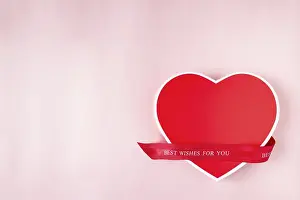 Red heart shaped gift box on pink background