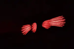 Red light reflections against a black background