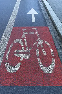 Red marked bicycle path on the roadway