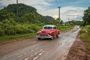 Framed Print : Red old american car drive on rural road in Cuban mountains Framed Print : Red old american car drive on rural road in Cuban mountains