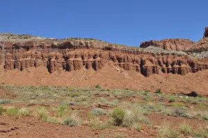 Red rock formation with low desert vegetation