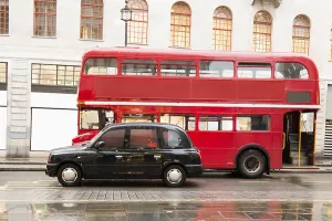 Red vintage bus and classic style taxi in London