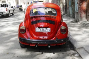Red Volkswagen Beetle on a city street