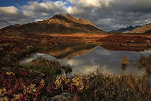 Reflection of mountains in a small lake in morning light