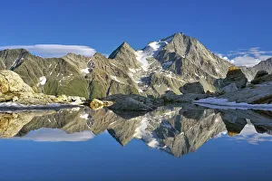 Reflection of the Oberalpstock in a mountain lake