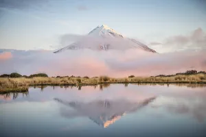 Reflection in Pouakai Tarn, stratovolcano Mount Taranaki or Mount Egmont at sunset