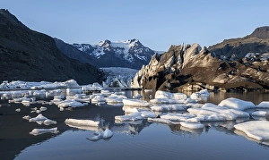 Reflection in the Svinafellslon glacier lagoon with ice floes