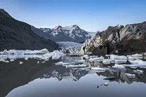 Reflection in the Svinafellslon glacier lagoon with ice floes