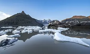 Reflection in the Svinafellslon glacier lagoon with ice floes