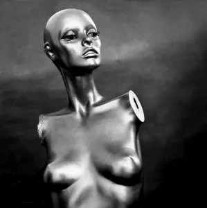 A reflective mannequin stands in a striking pose within a studio