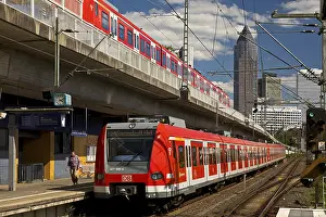 Two regional express trains on different levels at Frankfurt West station with Messeturm