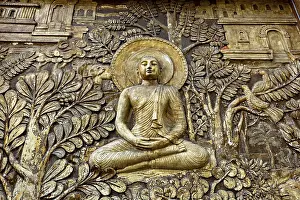 Relief depiction of Buddha in meditation surrounded by plants and architectural details