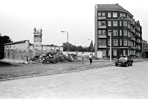 Remains of the Berlin Wall with a watchtower at Lohmuehlenstrasse road
