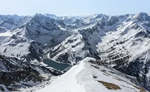 Reservoir, peaks and mountains in winter