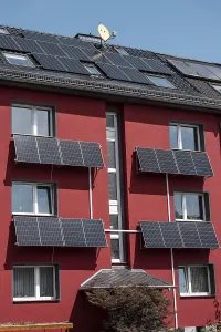 Residential building with photovoltaic modules on the facade and roof
