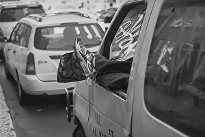 Resting motorist hangs his feet out of car window