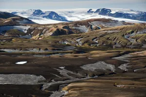 Rhyolite mountains covered with snow and ash on the Laugavegur hiking trail