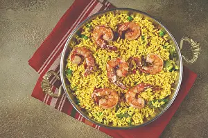 Rice with saffron and shrimp, in a frying pan
