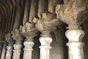 Richly carved pillars in Buddhist caves on mountain at Lenyadri