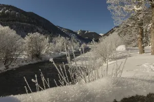 The Riss creek flowing through a snow covered landscape in the Eng valley
