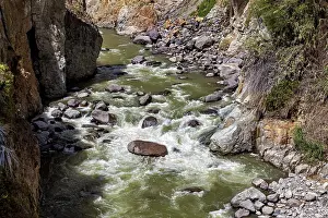 River with fast rapids flanked by rocks