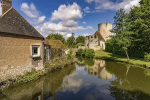The river Loir and the castle with donjon in Alluyes