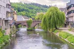 River with old stone bridge and overhanging willow in a peaceful