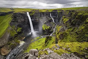 River and waterfalls at a canyon with green moss