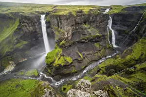 River and waterfalls at a canyon with green moss